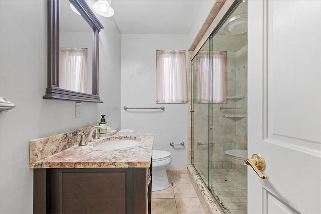 bathroom with toilet, vanity, tile patterned floors, and an enclosed shower