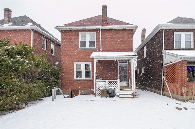 view of snow covered rear of property