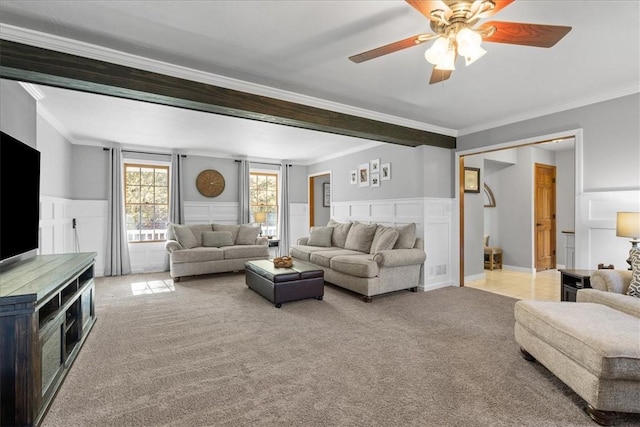 living room featuring light carpet, ceiling fan, and ornamental molding