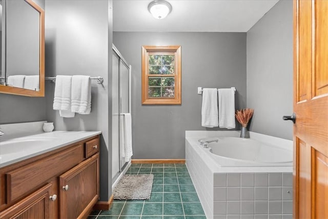 bathroom featuring tile patterned flooring, vanity, and separate shower and tub