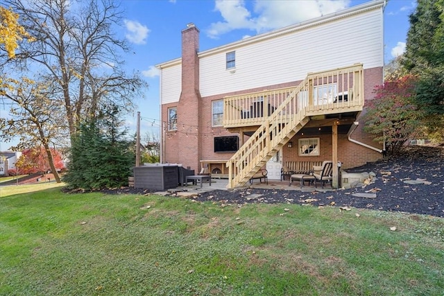 back of property with a wooden deck, an outdoor living space, a yard, and a patio