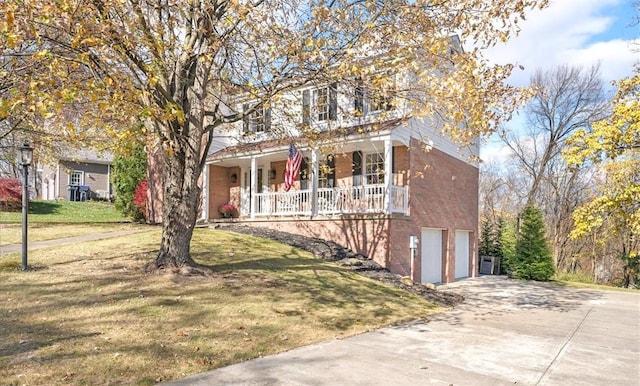 view of front facade featuring covered porch, a garage, and a front lawn