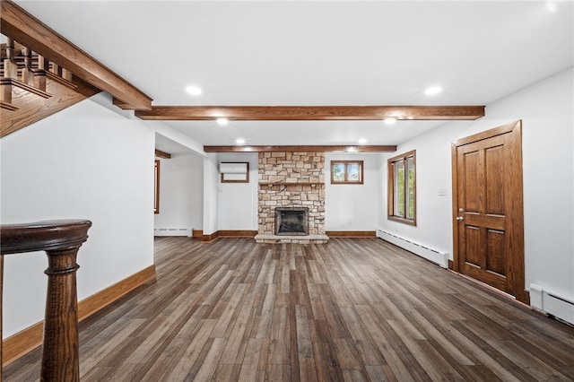 unfurnished living room with dark hardwood / wood-style floors, a stone fireplace, and baseboard heating