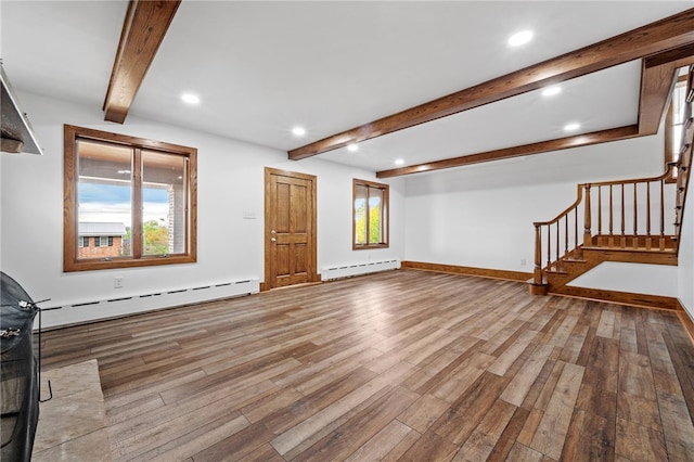 unfurnished living room with beam ceiling, light wood-type flooring, and a baseboard heating unit