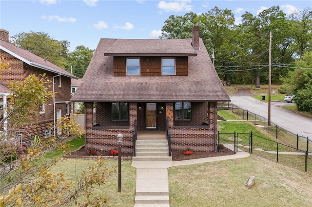 bungalow-style house featuring a front yard