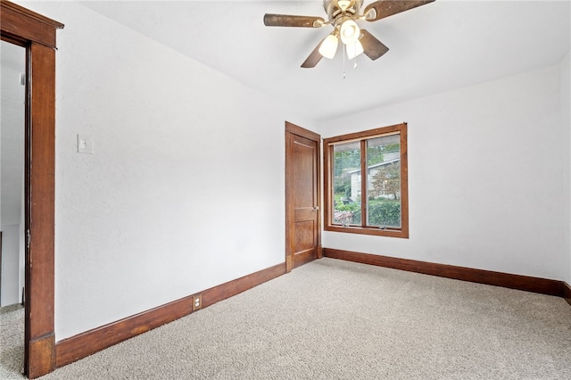 empty room featuring carpet flooring and ceiling fan