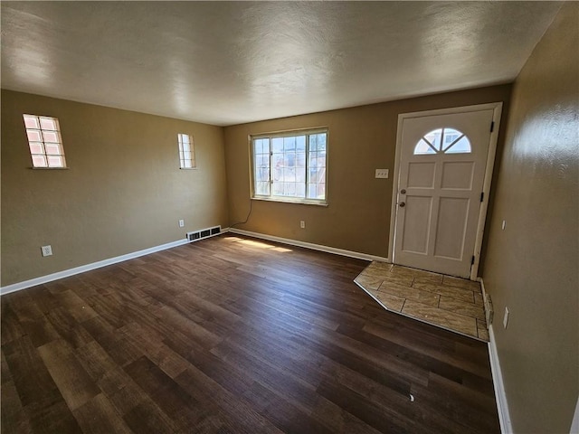 foyer entrance featuring dark hardwood / wood-style flooring