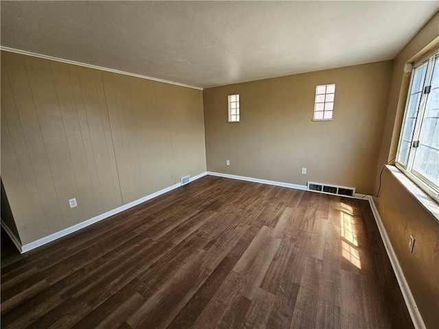 empty room with dark hardwood / wood-style floors