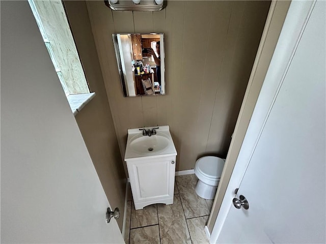 bathroom with tile patterned flooring, vanity, and toilet