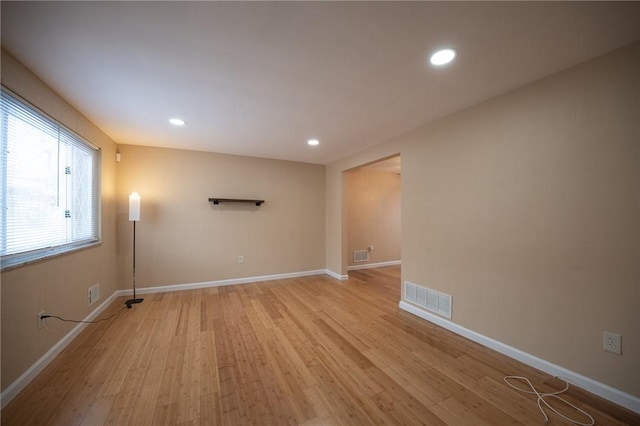 spare room with light hardwood / wood-style flooring