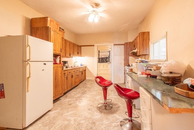 kitchen featuring white appliances and ceiling fan