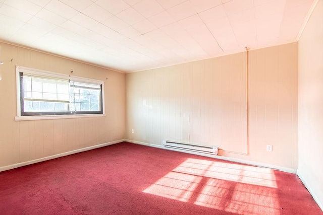 carpeted empty room featuring baseboard heating