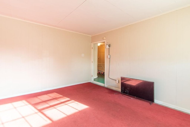 carpeted empty room featuring crown molding