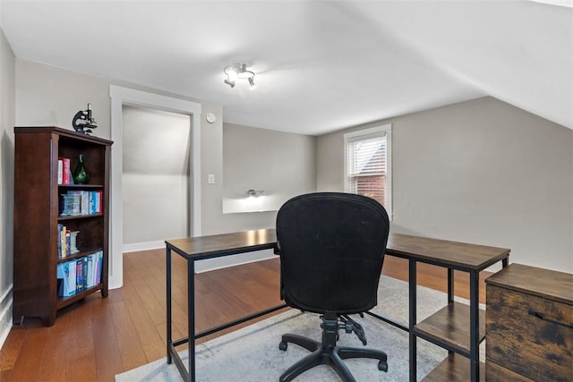 office space with lofted ceiling and dark wood-type flooring