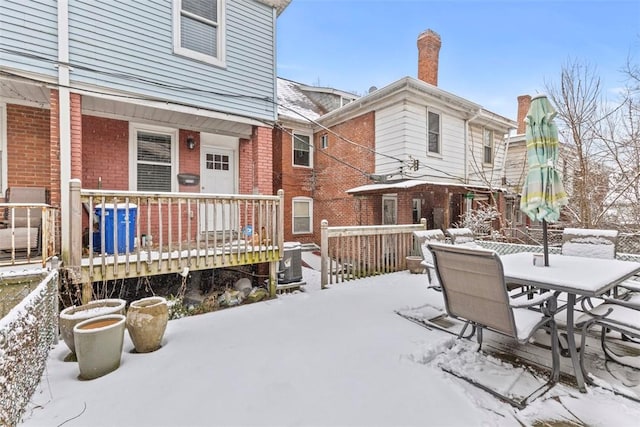 snow covered deck with central AC unit