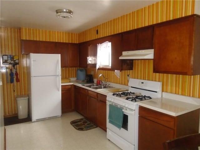 kitchen featuring sink and white appliances