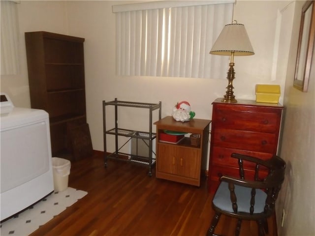 clothes washing area with washer / clothes dryer and dark wood-type flooring