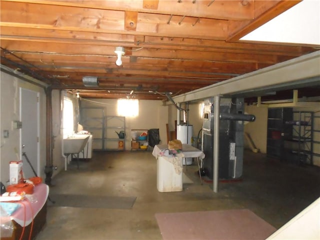 basement with gas water heater, sink, and heating unit