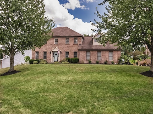 colonial-style house with a front yard