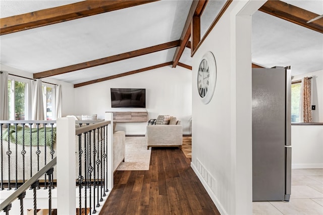 corridor with hardwood / wood-style flooring and vaulted ceiling with beams