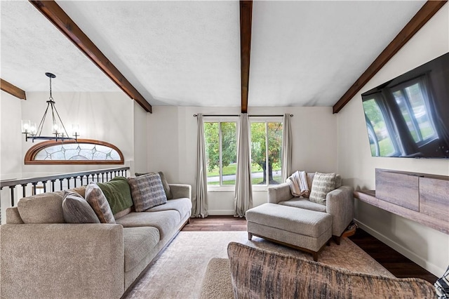 living room featuring vaulted ceiling with beams, hardwood / wood-style flooring, and a notable chandelier