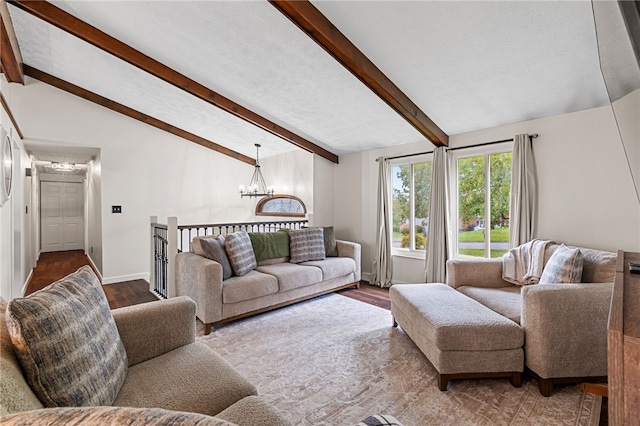 living room featuring hardwood / wood-style floors, lofted ceiling with beams, and a notable chandelier