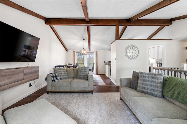 living room with a notable chandelier, lofted ceiling with beams, and wood-type flooring