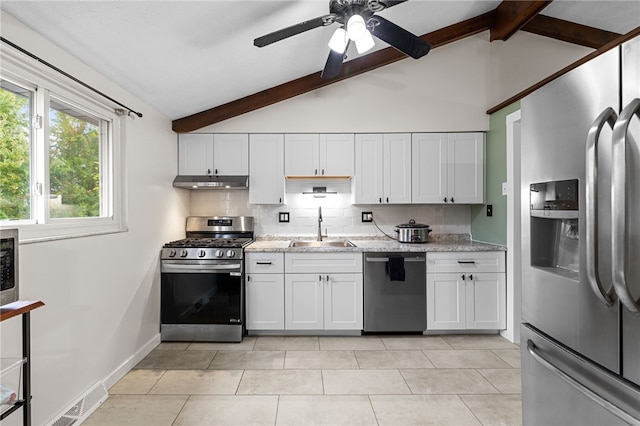 kitchen with white cabinetry, lofted ceiling with beams, sink, and stainless steel appliances