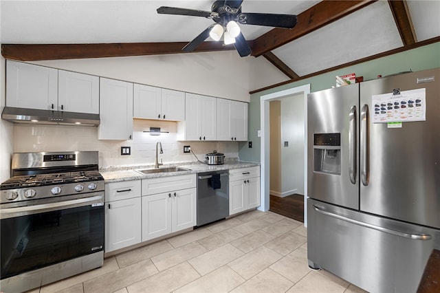 kitchen with sink, vaulted ceiling with beams, ceiling fan, appliances with stainless steel finishes, and white cabinetry