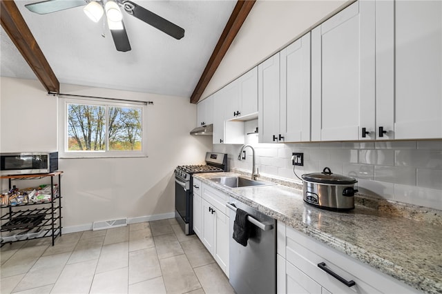 kitchen featuring white cabinetry, sink, lofted ceiling with beams, backsplash, and appliances with stainless steel finishes