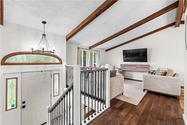 entryway with vaulted ceiling with beams, dark wood-type flooring, and a notable chandelier