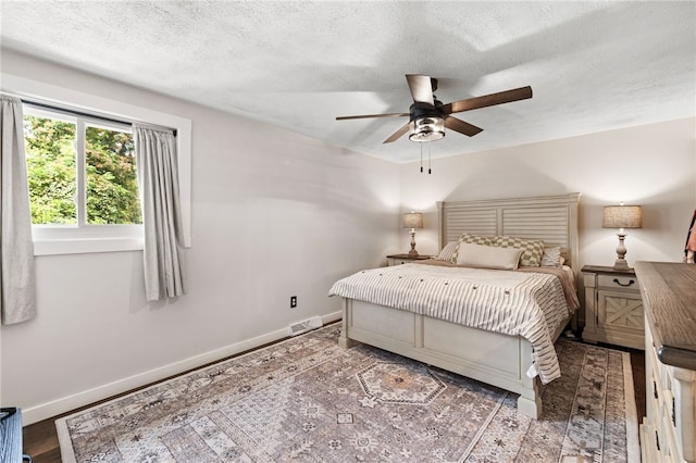 bedroom featuring a textured ceiling and ceiling fan