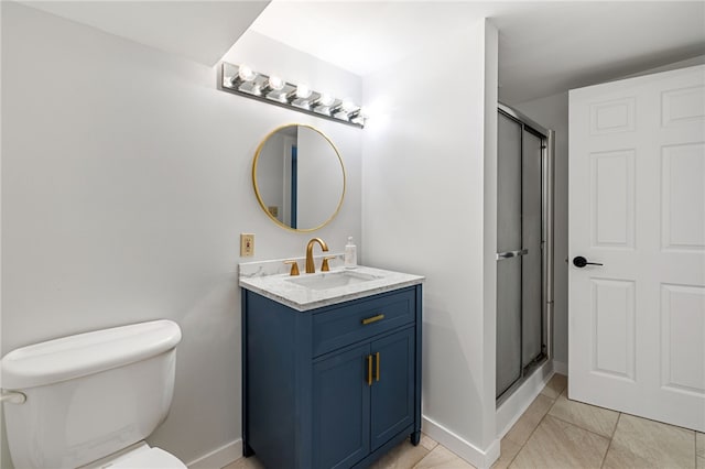 bathroom featuring tile patterned floors, vanity, toilet, and walk in shower