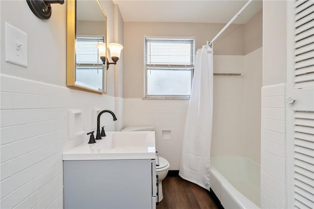 full bathroom featuring vanity, wood-type flooring, tile walls, and toilet