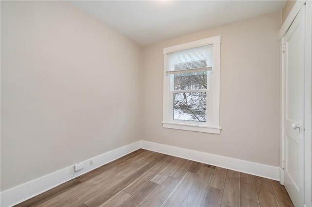 unfurnished bedroom featuring wood finished floors and baseboards