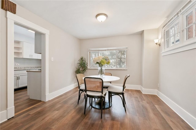 dining space featuring dark hardwood / wood-style flooring