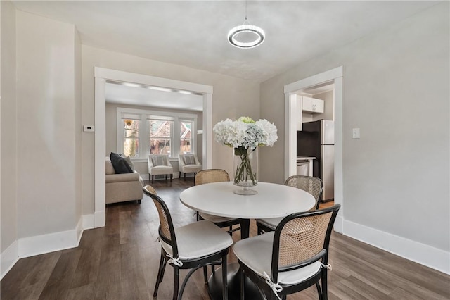 dining room with dark wood-style floors and baseboards