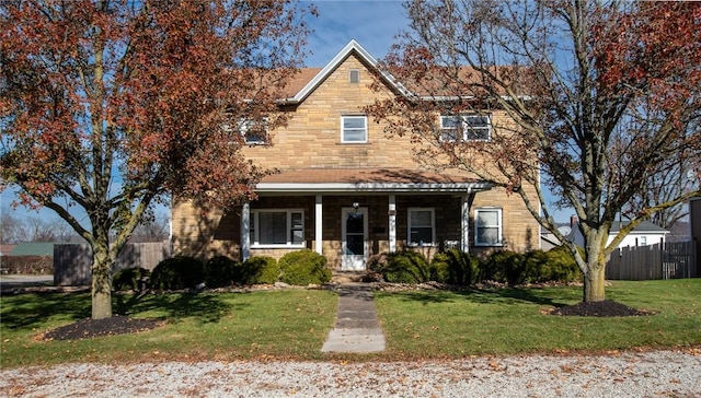 view of front facade featuring a front yard and covered porch