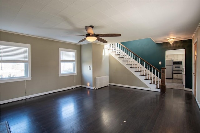 unfurnished living room with ceiling fan, dark hardwood / wood-style floors, crown molding, and radiator