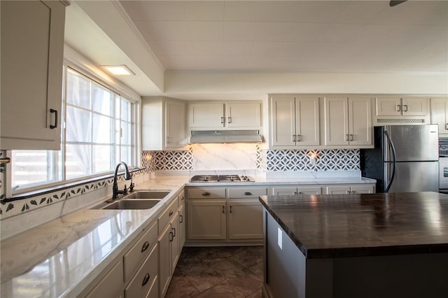 kitchen featuring stainless steel appliances, dark stone countertops, and sink