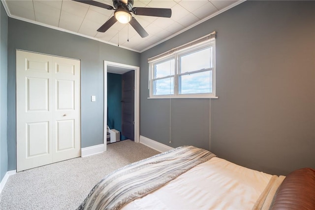 bedroom featuring ceiling fan, carpet floors, and ornamental molding