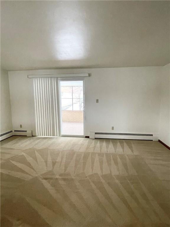 carpeted empty room with baseboard heating