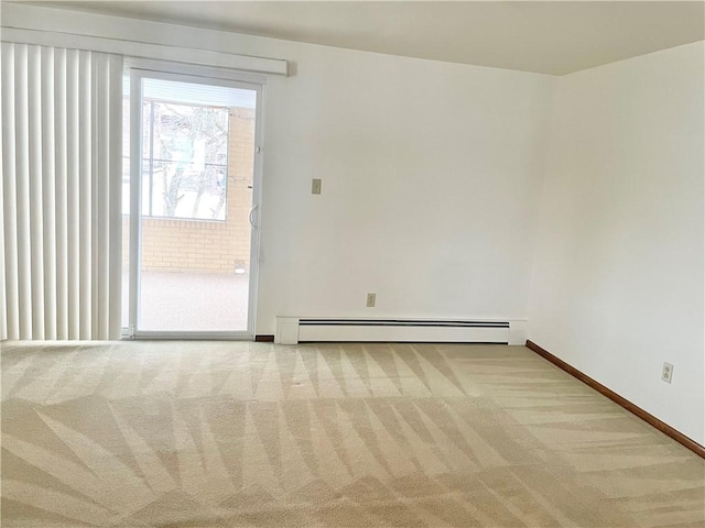 carpeted spare room with a baseboard radiator