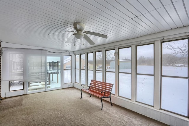 unfurnished sunroom with ceiling fan