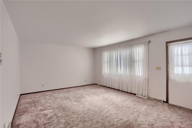 unfurnished room with light carpet