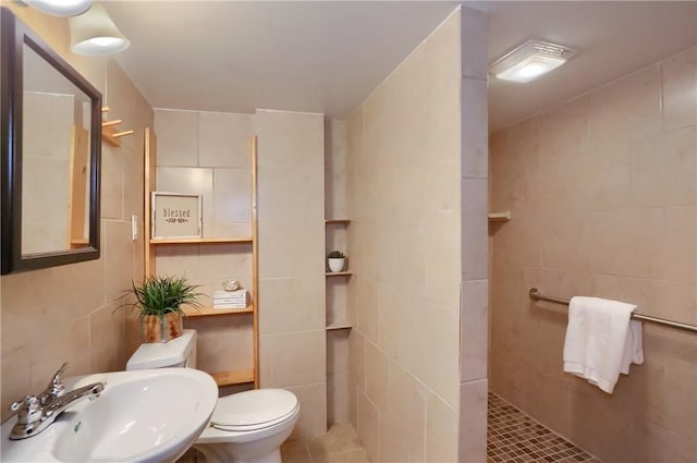 bathroom featuring walk in shower, toilet, tile walls, and sink