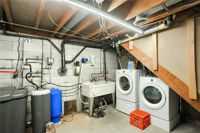 clothes washing area featuring washing machine and dryer and sink