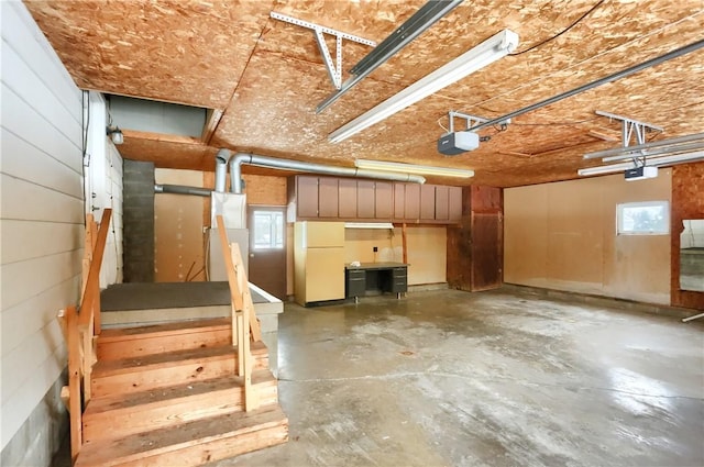 interior space featuring white fridge and a garage door opener