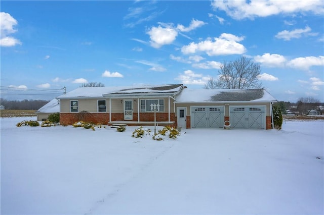 single story home featuring covered porch and a garage