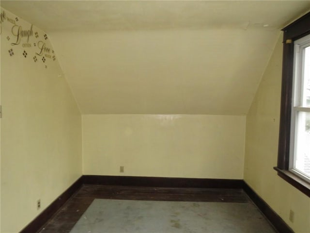 bonus room with a healthy amount of sunlight and vaulted ceiling